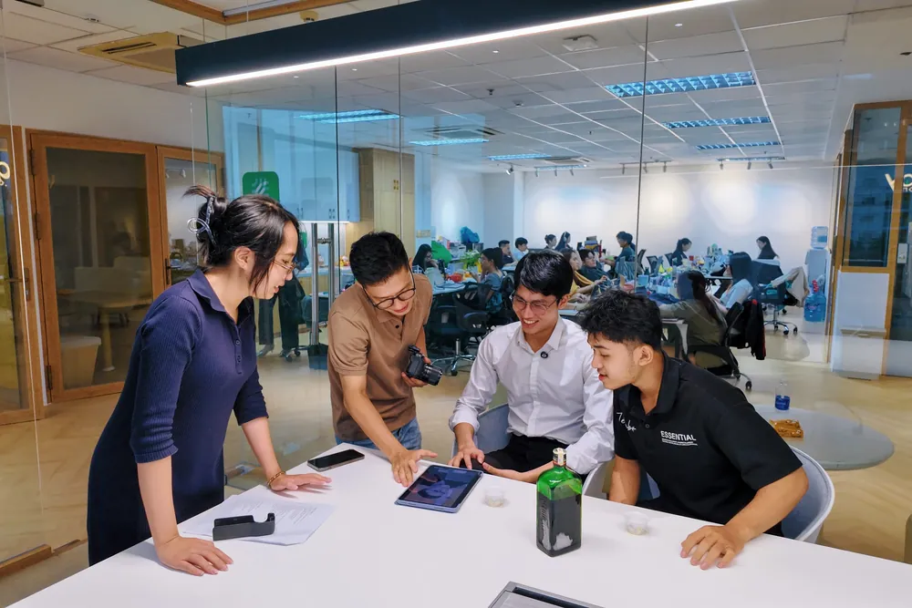 Kha reviewing footage on a tablet with the team